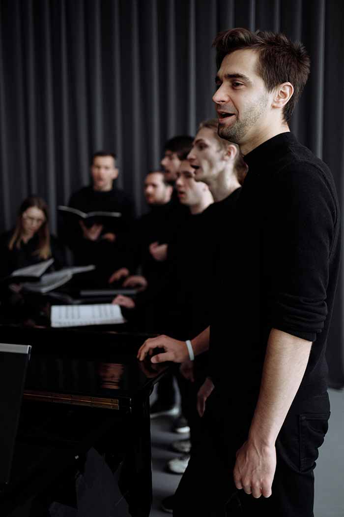 happy singing choir with conductor